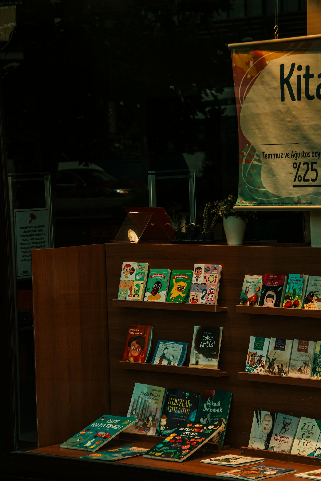 A vibrant display of children's books in a bookstore with a promotional banner.